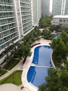 an overhead view of a large swimming pool in a city at 1bedroom with balcony in Manila