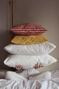 um monte de almofadas em cima de uma cama em Busola House em Stegna