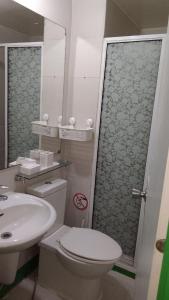 a bathroom with a toilet and a sink at 1bedroom with balcony in Manila