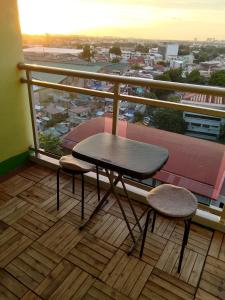a table and two chairs on a balcony with a view at 1bedroom with balcony in Manila