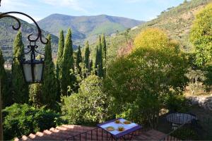 a table and a lamp with a view of a mountain at Collerosso Appartamenti per vacanze in Calci