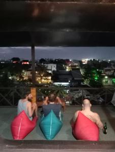 a group of people sitting on top of a roof at SECOND HOPE LODGE in Padang