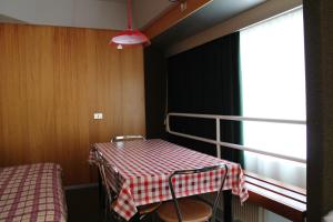 a room with a table with a checkered table cloth at Residence Albarè in Mezzana