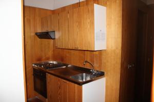 a small kitchen with a sink and a stove at Residence Albarè in Mezzana