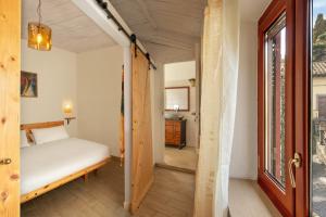a bedroom with a bed and a door to a hallway at Centro e Spiaggia ambra in Anguillara Sabazia