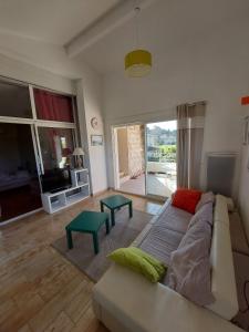 a living room with a couch and a tv at Mas Fontclaire - Sommières in Sommières