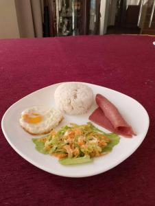 un plato de comida con arroz y carne y hortalizas en Aberrise Country Villa Pension Hotel, en Dumaguete