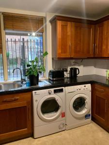 a kitchen with a washing machine and a sink at COBBOLD COURT share flat in London