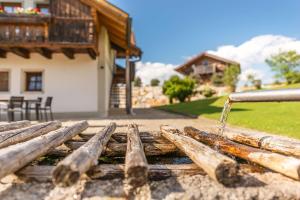 a stream of water coming out of a wooden fence at Edlgütl in Breitenberg