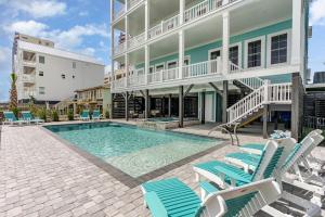 uma piscina com cadeiras e um edifício em Carolina Escape Luxury Oceanfront Home em Myrtle Beach