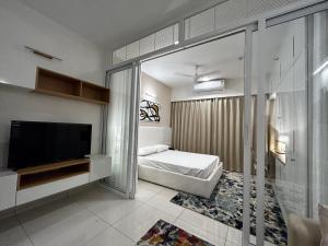 a bedroom with a bed and a television in it at Boulevard in Bengaluru