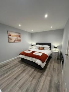a bedroom with a large bed and a wooden floor at Mary McGill’s in Ballycastle
