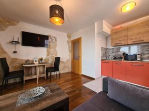 a kitchen and a living room with a table at Downtown Apartment Bepi in Opatija
