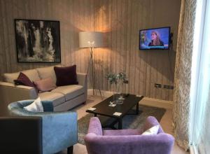 a living room with a couch and two chairs and a table at Star Apartment York City Centre - Self Check-in in York