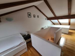 a bedroom with a bed and a white wall at Downtown Apartment Bepi in Opatija