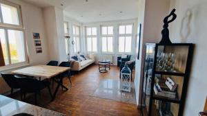 a living room with a table and a couch at Villa Anna Meerblick erste Reihe in Ahlbeck
