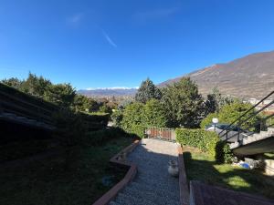 a garden with a pathway and a mountain in the background at Il Rifugio di Carmine in Castel di Sangro