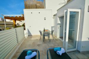 a balcony with a table and chairs on a patio at Blue Serenity by Hello Homes Sitges in Sitges