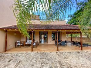 a house with a patio with chairs and tables at Vipingo Ridge limited in Kilifi