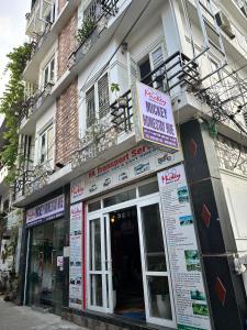 a store front of a building with a sign on it at Mickey Homestay Hue in Hue +61 photos