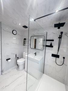 a bathroom with a toilet and a sink and a shower at Home near London Heathrow, Slough,Windsor,Legoland in Colnbrook