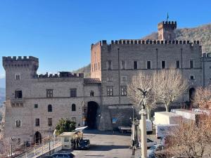 a large castle with a gate in front of it at La casa nel Borgo in San Gregorio da Sassola