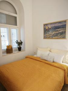 um quarto com uma cama com um cobertor laranja em Apartments Karuza Center of old town Vis em Vis