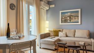a living room with a couch and a table at Agora Apartment in Pythagoreio