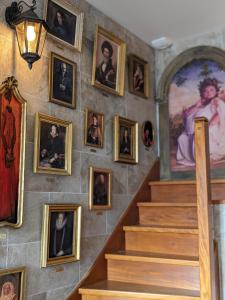 a wall of portraits of people on a staircase at Le Quai des sorciers 15 minutes de Lille in Haubourdin