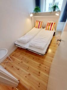 a small bedroom with a bed and a window at Charming Apartment On Pedestrian Street Randers in Randers