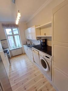 a kitchen with a washer and dryer and a window at Charming Apartment On Pedestrian Street Randers in Randers