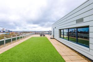 a view from the balcony of a building with grass at Modern Duplex 2 Bedroom Apartment With Balcony in Manchester