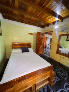 Postel nebo postele na pokoji v ubytování Hostal Vista Hermosa