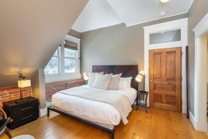 a bedroom with a large bed and a wooden door at Ajax Loft apts in Telluride