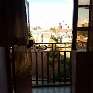 a door to a balcony with a view of a city at Verona Airbnb in Thika