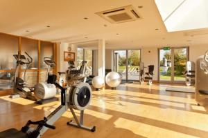 a gym with treadmills and exercise equipment in a room at Blueberry Cottage - Lower Mill Estate in Somerford Keynes
