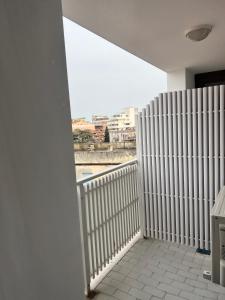 a room with a balcony with a view of a city at Hotel Lydia in Grado