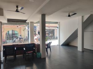 a room with a table and chairs and a staircase at Hotel HV in Nāhan