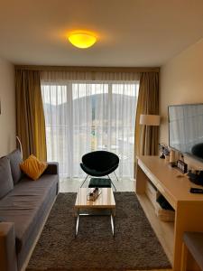 a living room with a couch and a table at Apartament Czarna Góra in Sienna