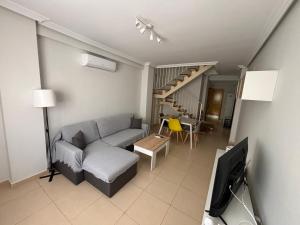 a living room with a couch and a tv at Duplex entre molinos in Consuegra