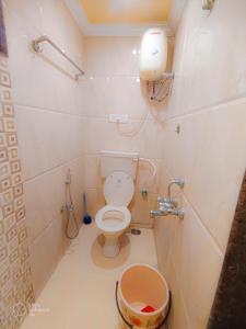 a small bathroom with a toilet and a shower at Shradha luxury room in Calangute