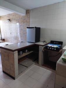 a kitchen with a counter and a stove in it at Alojamientos Nazareth in Catia La Mar