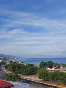 a view of a city with the ocean in the background at Alojamientos Nazareth in Catia La Mar