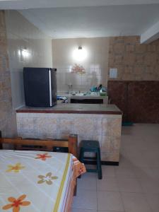 a kitchen with a sink and a counter with a tv at Alojamientos Nazareth in Catia La Mar