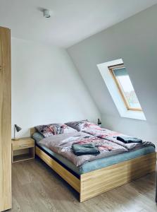 a bedroom with a bed in a attic at Perła Mazur przy Promenadzie Mikołajki in Mikołajki