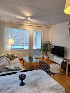 a living room with a couch and a table at two-room apartment midle in Kotka with sauna in Kotka