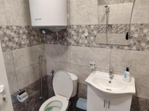a small bathroom with a toilet and a sink at АРТ 3 in Sliven