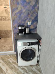 a washing machine with a coffee maker on top of it at АРТ 3 in Sliven