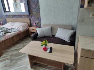 a small living room with a couch and a table at АРТ 3 in Sliven