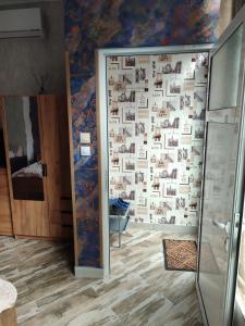a bathroom with a wall with photographs on it at АРТ 3 in Sliven